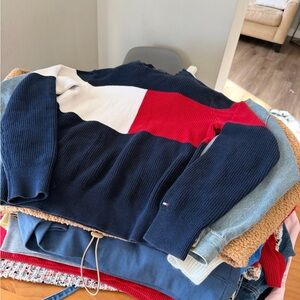 Lot of 21 women's sweaters in assorted sizes.